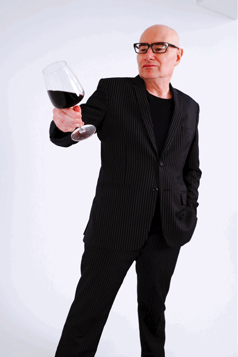 Philippe holding a glass of red wine