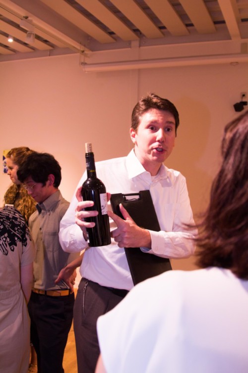 Paul, wine consultant, presenting a bottle at a Tokyo Wine Events dinner